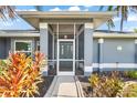 Front view of a charming house with teal door at 15490 Mccomb Cir, Port Charlotte, FL 33981