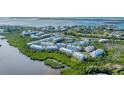 Aerial view showcasing the community's waterfront location and expansive layout at 10311 Lands End Cir # 13, Placida, FL 33946