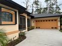 One-story home with orange garage door at 5160 Farewell St, Port Charlotte, FL 33981