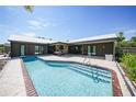 Inviting kidney-shaped pool with concrete decking at 12325 Mitchell Ter, Port Charlotte, FL 33981
