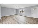 Bright and spacious living room with light gray walls and wood-look floors at 19483 Midway Blvd, Port Charlotte, FL 33948