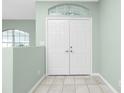 Interior view of double doors and sage green walls at 217 Rotonda Cir, Rotonda West, FL 33947