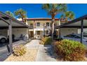 Well-maintained condo building with covered parking and lush tropical landscaping at 404 Pine Hollow Cir # 404, Englewood, FL 34223