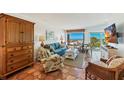 Relax in this bright living room with access to beach views, beautiful furnishings, and unique flooring at 5000 Gasparilla Rd # Dc206, Boca Grande, FL 33921