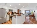 Modern kitchen with stainless steel appliances and terracotta tile floors at 5000 Gasparilla Rd # Dc206, Boca Grande, FL 33921