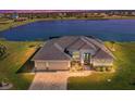 Stunning waterfront home with three-car garage; beautiful lake view at dusk at 75 Master Dr, Placida, FL 33946