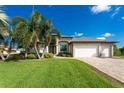 Single-Gathering home with three-car garage and lush landscaping at 230 Long Meadow Ln, Rotonda West, FL 33947