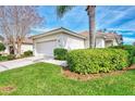 Single-story home with attached garage and lush landscaping at 3390 Osprey Ln, Port Charlotte, FL 33953