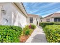 Home exterior showcasing a walkway, landscaping, and building facade at 3390 Osprey Ln, Port Charlotte, FL 33953