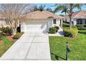 Single story home with attached garage and well-maintained landscaping at 3390 Osprey Ln, Port Charlotte, FL 33953