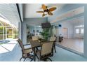 Covered patio with seating area, adjacent to the pool and offering views of the house at 110 Abercrombie Ave, Englewood, FL 34223