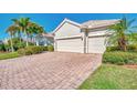 Three car garage with paver driveway and landscaping at 13025 Cedar Creek Dr, Port Charlotte, FL 33953
