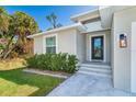 Inviting front entrance with a modern door and landscaping at 152 Apollo Dr, Rotonda West, FL 33947