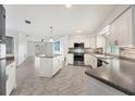 Renovated kitchen with island and stainless steel appliances at 165 Spyglass Aly, Placida, FL 33946