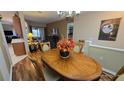 Spacious dining room featuring a rich wood table and hardwood floors at 24412 Lakeview Pl, Punta Gorda, FL 33980