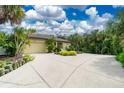 Home's exterior showcasing a large driveway at 3075 Bay Oaks Cir, Englewood, FL 34223