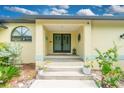 Front entry with double doors and landscaping at 3075 Bay Oaks Cir, Englewood, FL 34223
