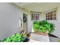 Front entrance with a door, plants, and a mailbox at 3393 Grand Vista Ct # 201, Port Charlotte, FL 33953