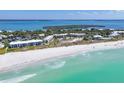 Aerial showing beachfront property, ocean, and white sand beach at 5000 Gasparilla Rd # Dc102, Boca Grande, FL 33921