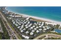Aerial view of community near beach, pool, and tennis courts at 5000 Gasparilla Rd # Dc102, Boca Grande, FL 33921