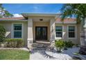 Well-maintained house exterior with double doors and landscaping at 5208 Churchill Rd, Port Charlotte, FL 33981