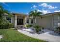 Charming house exterior with double doors and landscaping at 5208 Churchill Rd, Port Charlotte, FL 33981