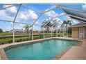 Screened-in pool and patio with canal views at 665 Rotonda Cir, Rotonda West, FL 33947