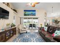 Spacious living room with leather sofas, a large TV, and sliding glass doors leading to a patio at 665 Rotonda Cir, Rotonda West, FL 33947