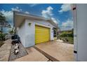 Side view of the house with yellow garage door at 1165 Oxford Dr, Englewood, FL 34223