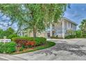 Two-story house with a two-car garage and lush landscaping at 14080 Willow Glen Ct # 233, Port Charlotte, FL 33953