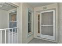 Condo front door with screen door and balcony access at 14080 Willow Glen Ct # 233, Port Charlotte, FL 33953