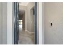 Open door revealing a view of the interior hallway at 19536 Fishhawk Trl, Venice, FL 34293