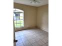 Simple bedroom with tile floor and large window at 2564 Parrot St, North Port, FL 34286