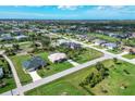 Birds-eye view of a residential neighborhood with houses and canals at 3 Pinehurst Ct, Rotonda West, FL 33947