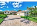 Beautiful home with three-car garage and lush landscaping at 3031 Rivershore Ln, Port Charlotte, FL 33953