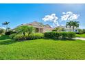 Single-Gathering home with manicured lawn and tropical landscaping at 3270 Bay Ridge Way, Port Charlotte, FL 33953