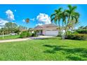 Single-Gathering house with lush lawn and palm trees at 3270 Bay Ridge Way, Port Charlotte, FL 33953