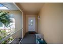 Covered entryway with white door and bench at 34 Golfview Ct, Rotonda West, FL 33947