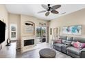 Living room featuring a gray sectional sofa, fireplace, and access to a lanai at 4261 Oak Terrace Cir, Port Charlotte, FL 33953