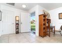 Bright and airy entryway with wood shelving and a view of backyard at 5214 Norlander Dr, Port Charlotte, FL 33981