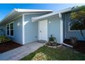 Front entrance with white door and light blue siding at 5214 Norlander Dr, Port Charlotte, FL 33981
