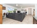 Spacious living room with large sectional sofa and big windows at 5214 Norlander Dr, Port Charlotte, FL 33981