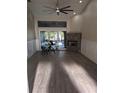 Bright Gathering room featuring a stone fireplace and sliding glass doors leading to the backyard at 705 Chevy Chase Nw St, Port Charlotte, FL 33948