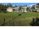 Single story home with green exterior, attached garage, and spacious lawn at 705 Chevy Chase Nw St, Port Charlotte, FL 33948