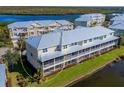 Back view of townhome showing private patio and waterfront location at 10325 Longshore Rd # 17, Placida, FL 33946