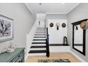 Bright entryway with staircase, built-in bench, and mirror at 10325 Longshore Rd # 17, Placida, FL 33946