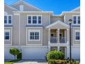Townhouse exterior featuring a two-story design and attached garage at 10325 Longshore Rd # 20, Placida, FL 33946