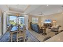 Open living and dining area with water views and modern furnishings at 10325 Longshore Rd # 20, Placida, FL 33946