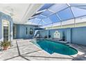 Relaxing kidney-shaped pool with covered patio and fountain at 10399 Coquina Ct, Placida, FL 33946