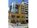 Modern condo building with yellow exterior and ground floor retail at 1120 E Kennedy Blvd # 1423, Tampa, FL 33602